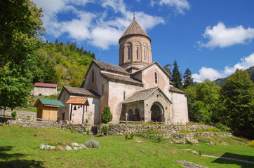 Fototapeta na wymiar Timotesubani is a medieval Georgian Orthodox Christian monastic complex. The church is built of pink stone. Georgia, Samtskhe-Javakheti region, Borjomi Gorge