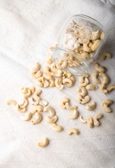 cashew nuts in a glass jar and on a table