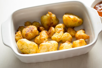 Cauliflower popcorn, coated mini cauliflower florets in a light batter with a spicy Buffalo dip