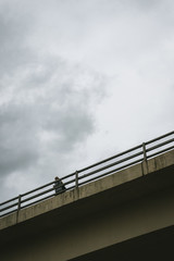 Woman Crossing On The Bridge