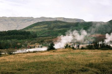 Plakat stunning Iceland geyser steam and mountains in plains