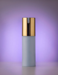 white spray with gold cup on purple background 