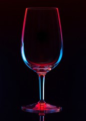 wine glass on black background. colors red and blue 