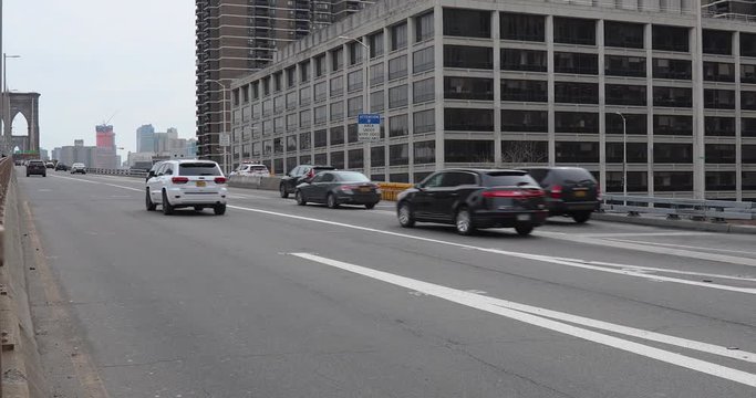 Vehicles travel on the entrance of the Brooklyn Bridge in New York City, NY. 