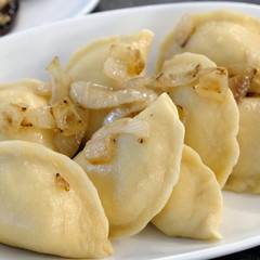 Boiled Dumplings with Onions on a white plate. Food photography