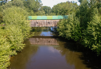 Fototapeta premium Hammond Covered Bridge in Vermont. reflecting in calm river.