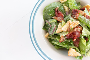 Closeup of healthy Caesar salad with croutons and Ham sliced