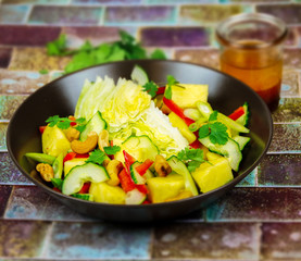 Thai pineapple salad with pepper, cucumber, lettuce, cilantro and dressing