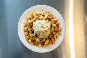 Yuca fried with hummus sauce.