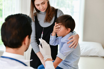 Fototapeta premium Terrible medical concept. Children are afraid of syringes. The doctor is injecting patients.