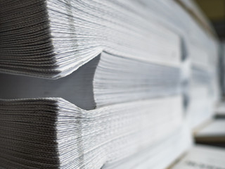 Fototapeta premium Large amount of paper. Pile of paper products. Production shop of printing house