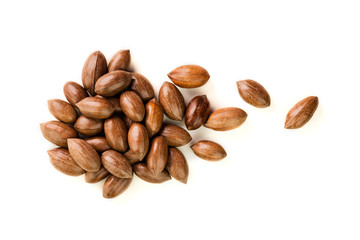 Not cleaned pecan nuts in the shell isolated on white.