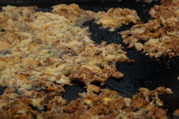 Hoi Tod or Thai Style Crispy Fried Oysters and  Mussel Pancakes , Hot Pan Seafood .