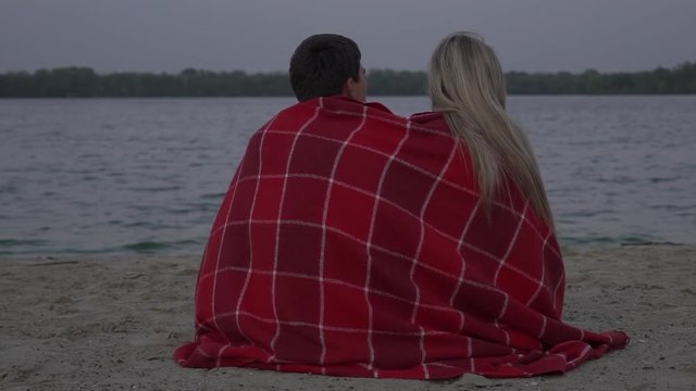 Slow Motion Couple Sitting On The Beach