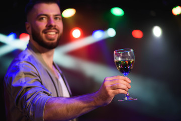 Man offering champagne and flirting at party