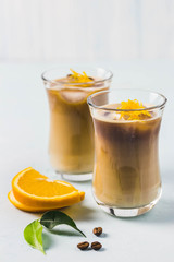 Orange iced latte. Selective focus, space for text.