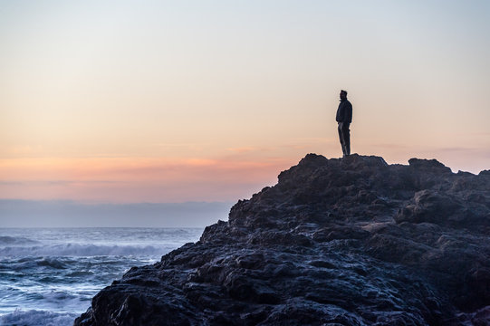 Man looking at view while standing on rock