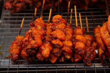 chicken grilled , thai street food in market .