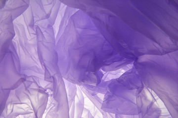 Obraz premium Plastic bag background. Purple abstract soft background. Suitable as a blank for a wedding invitation, greeting card or advertising. Plastic concept.