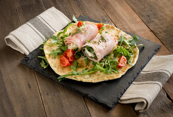 rolls of cooked ham stuffed with crescenza cheese