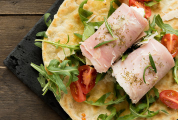 rolls of cooked ham stuffed with crescenza cheese