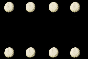Falling marshmallow on a black background.