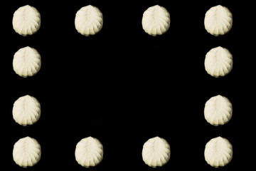 Falling marshmallow on a black background.