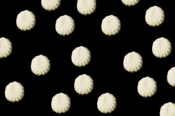 Falling marshmallow on a black background.