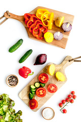 Vegan food cooking with raw vegetables on white background top view