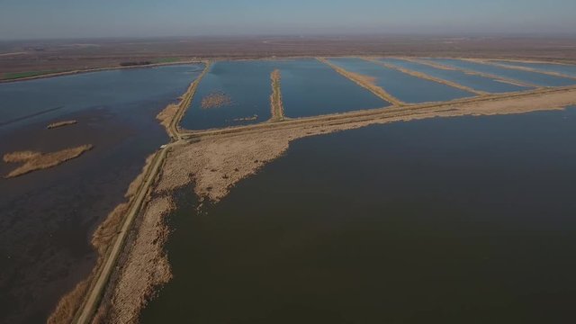 Fish Farming is a wonderful stock video that contains footage of an aerial footage of a vast fish farm in the countryside. This 3bit of footage will look beautiful in any video project 
