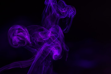 Fototapeta premium Colorful smoke close-up on a black background