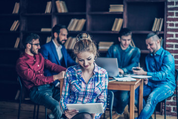 assistant young woman with laptop on the background of business 
