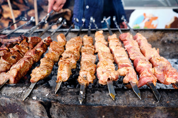 Grilled kebab cooking on metal skewer. Roasted meat cooked at barbecue. BBQ fresh beef meat chop slices. Traditional eastern dish, shish kebab.