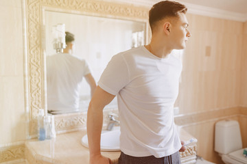 morning hygiene, the guy leaned on the washbasin in the bathroom