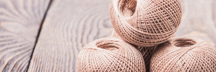 Obraz premium Balls of yarn thread for knitting on a wooden background.