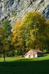The old barn in autumn mountain view with  the rock at background in Lauterbrunnen valley in Switzerland.