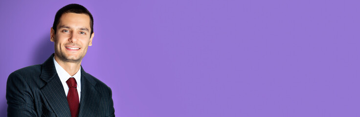 Happy businessman with crossed arms, on violet