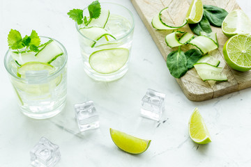 healthy drinks with lime and ice for summer on white background