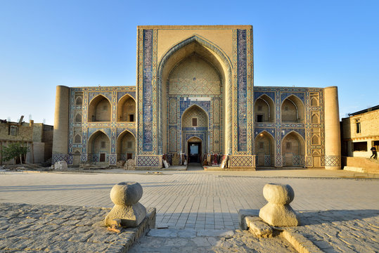View of Ulugbek Madrasah against blue sky in Bukhara, Uzbekistan