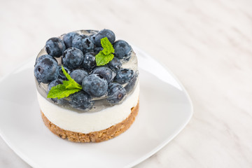 Blueberry cheesecake, serving portion with fresh mint