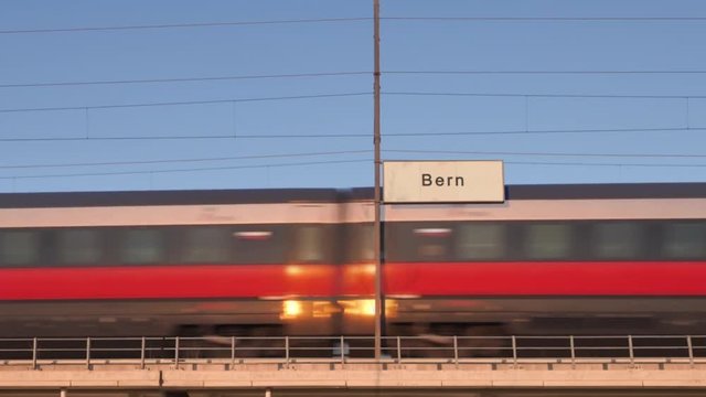 bern railway billboard train passing behind train station signboard
