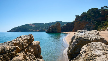 Beautiful nudist beach of Platja de Pals, Costa Brava, Girona - Spain. Rocky rough coastline. Mountain vegetation beautiful summer day. Common tourism destination for French, Dutch, German, English.