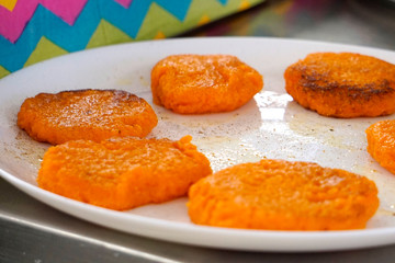  fried carrot fritters on a plate   