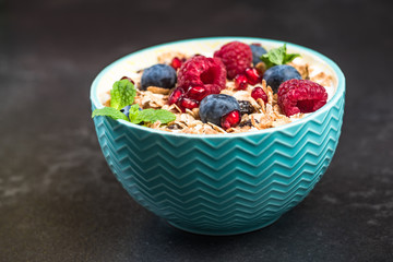 Bowl of homemade granola with yogurt and fresh berries
