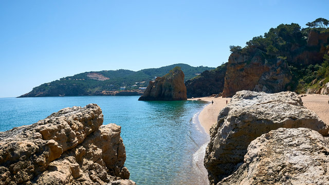 Beautiful nudist beach of Platja de Pals, Costa Brava, Girona - Spain. Rocky rough coastline. Mountain vegetation beautiful summer day. Common tourism destination for French, Dutch, German, English.
