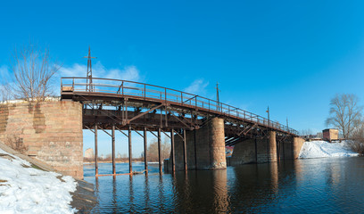 Kommunar dam, a pedestrian bridge over the Miass river
