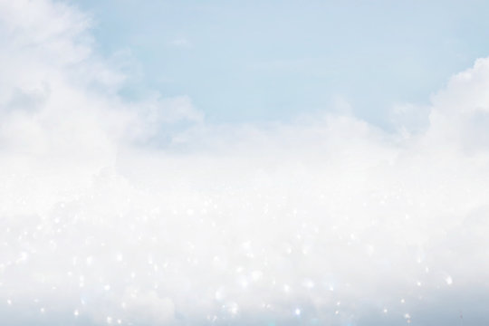 image of clouds in the blue sky with glitter