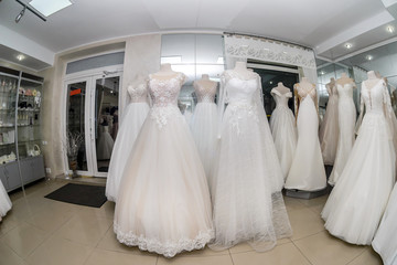 Fototapeta na wymiar Shop interior with wedding dresses on mannequins