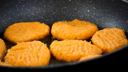 fried carrot fritters in a pan