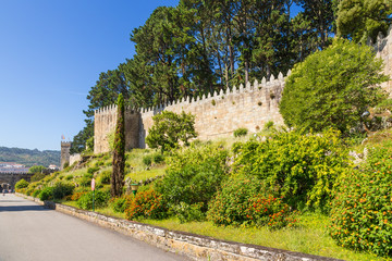 Fototapeta na wymiar Baiona, Spain. Wall with towers of the fortress of Monterreal, XI - XVII centuries. Included in the list of the most picturesque historical buildings of UNESCO